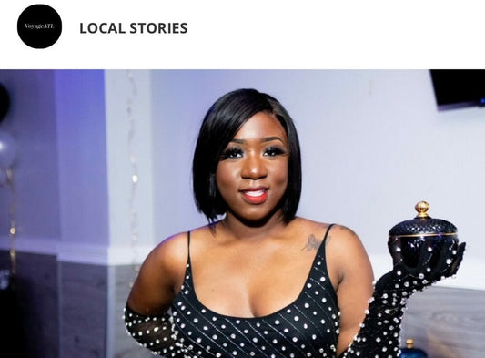 Modupe Babalola, founder of Lofinda Luxury, holding one of her eco-friendly soy candles with a warm smile.